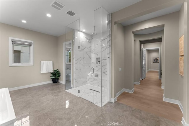 bathroom featuring a shower with door and wood-type flooring