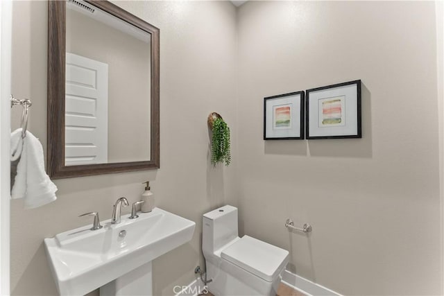 bathroom featuring toilet and sink