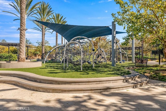 view of home's community featuring a playground and a lawn