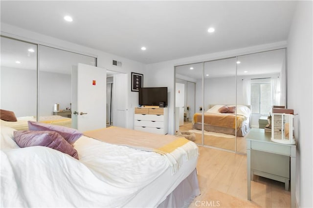 bedroom with a closet and light wood-type flooring