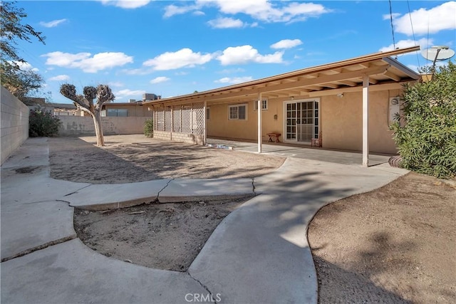 back of property with a patio