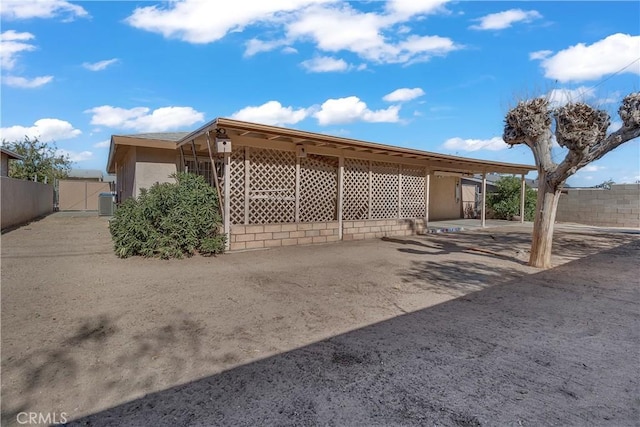 view of home's exterior with a carport and cooling unit