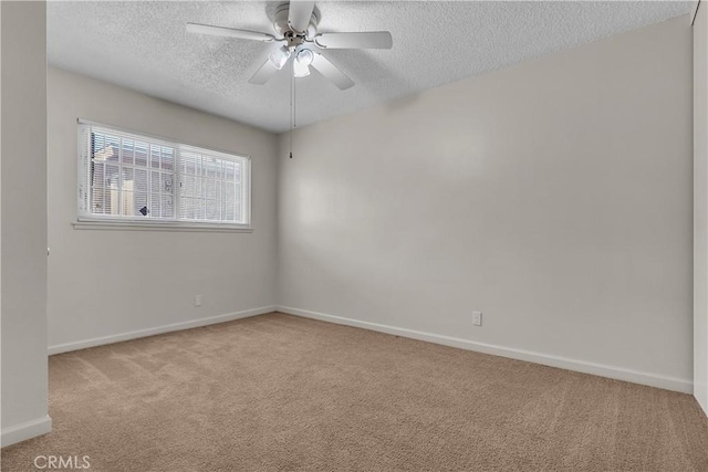 carpeted spare room with a textured ceiling and ceiling fan