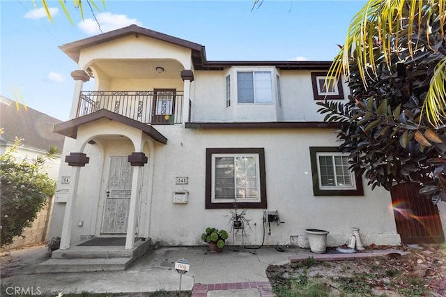 view of front of property with a balcony