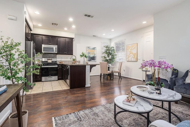 living room with sink and hardwood / wood-style floors