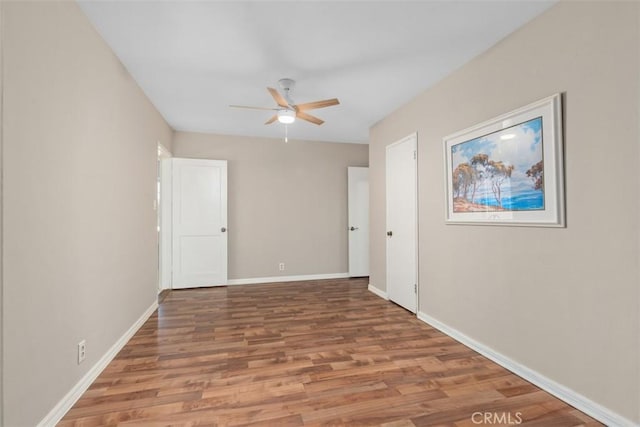 empty room featuring ceiling fan and wood-type flooring