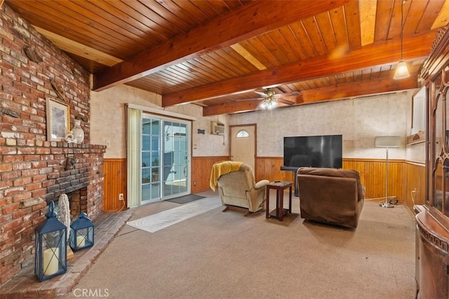 living room featuring beam ceiling, ceiling fan, wooden walls, and carpet flooring