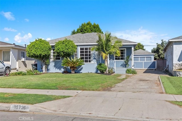 view of front of house with a front yard and a garage