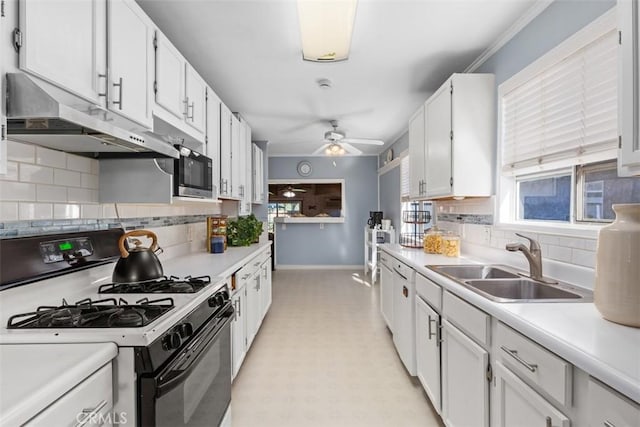 kitchen with decorative backsplash, ceiling fan, sink, white cabinets, and black gas stove