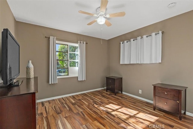 unfurnished bedroom featuring hardwood / wood-style flooring and ceiling fan