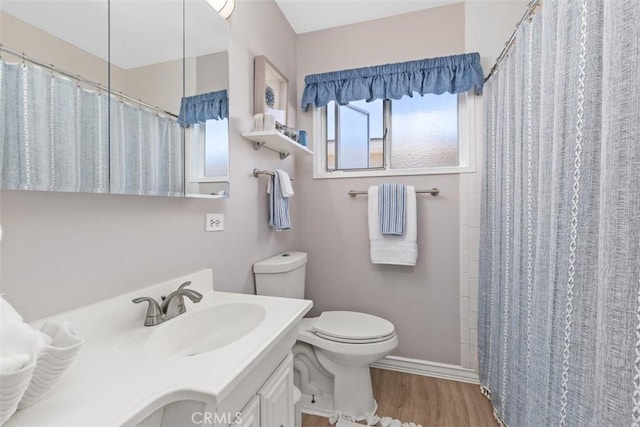 bathroom featuring hardwood / wood-style floors, vanity, a shower with shower curtain, and toilet