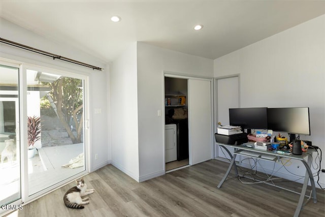 office featuring hardwood / wood-style flooring and washer / dryer