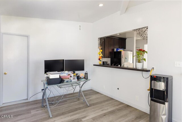 office with beamed ceiling and light hardwood / wood-style floors