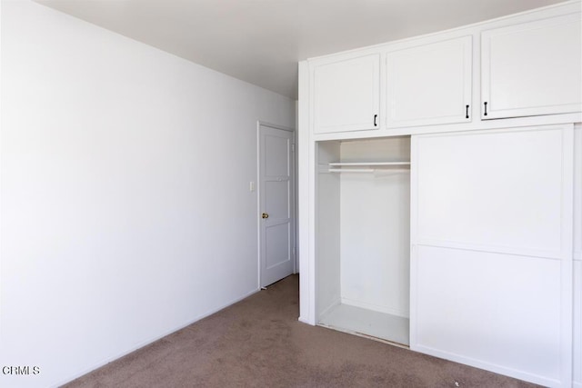 unfurnished bedroom with carpet and a closet