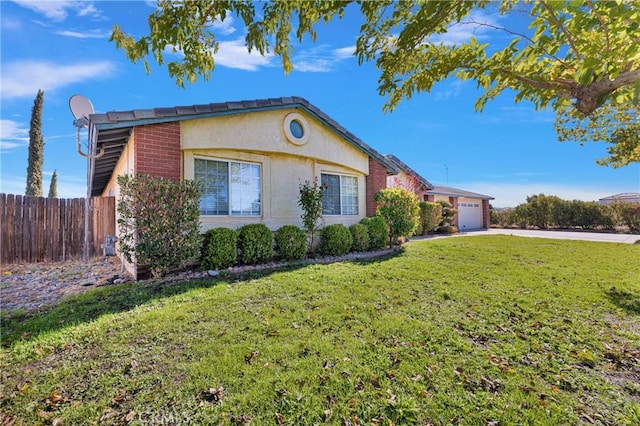 view of side of property with a garage and a lawn