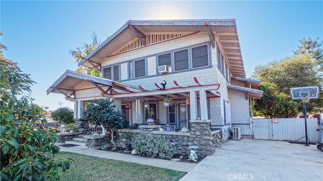 view of front of house with a porch and cooling unit