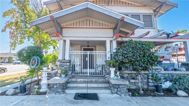 view of exterior entry with covered porch