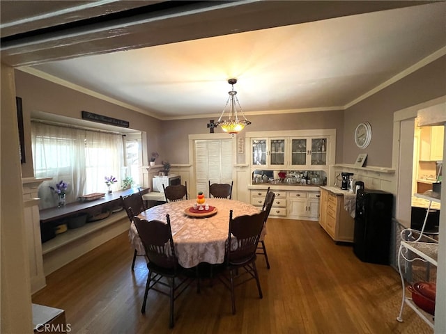 dining room featuring crown molding and dark hardwood / wood-style flooring