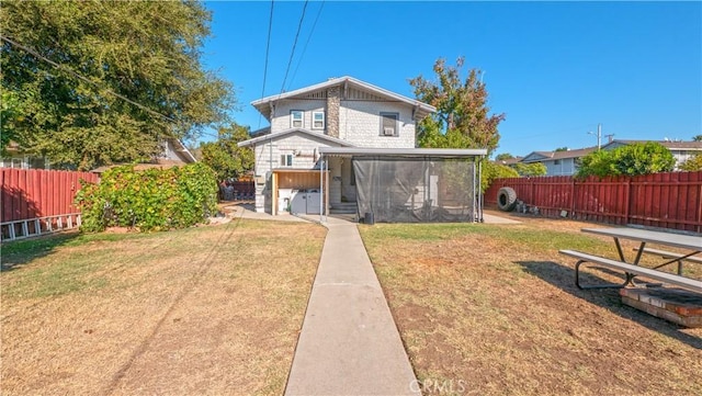 back of house with a yard