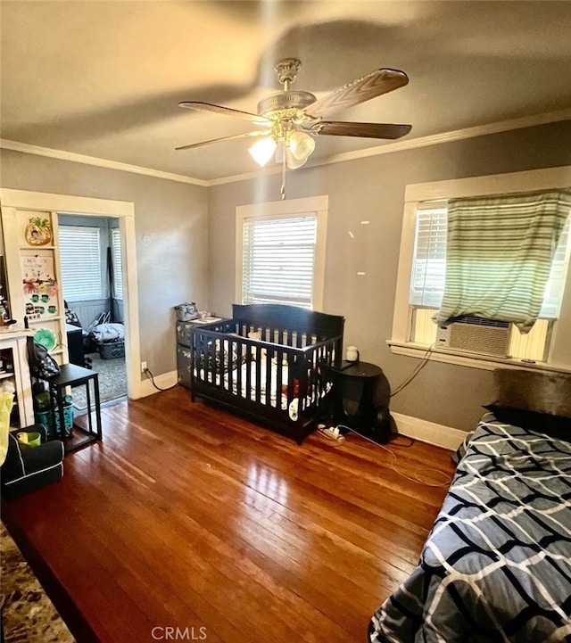 bedroom with ceiling fan, dark hardwood / wood-style flooring, and ornamental molding