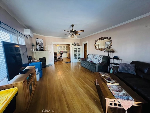 living room with crown molding, hardwood / wood-style floors, ceiling fan, and a wall mounted air conditioner