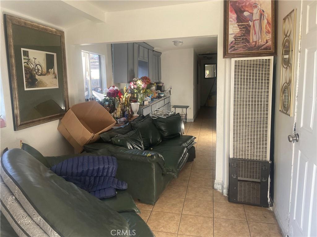 tiled living room with beamed ceiling