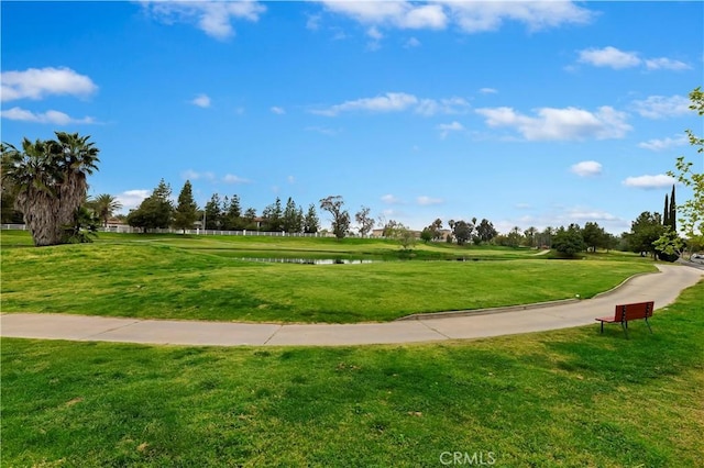 surrounding community featuring a lawn and a water view