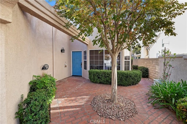 entrance to property featuring a patio area