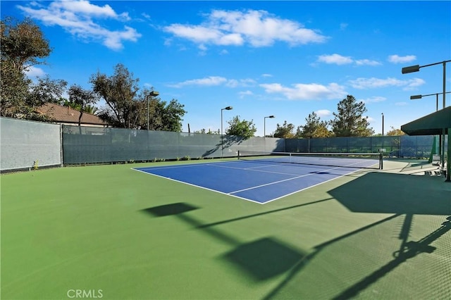 view of tennis court featuring basketball court