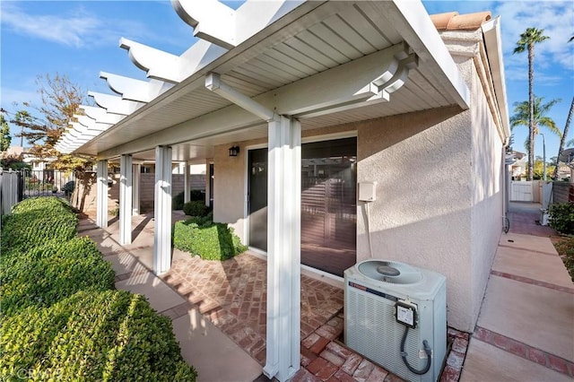 doorway to property with a patio and cooling unit