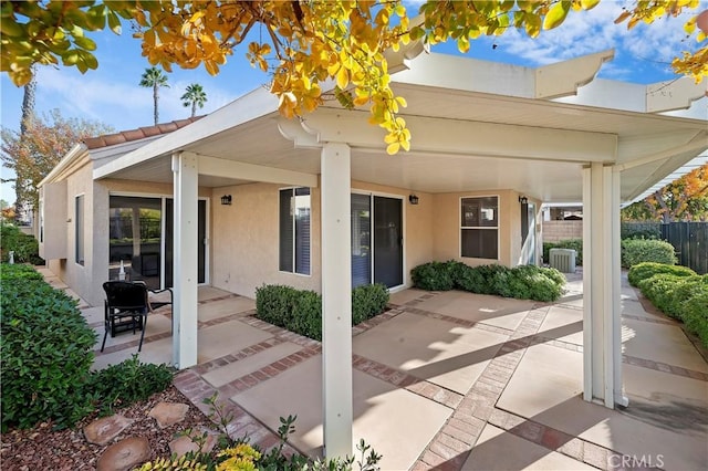 exterior space with central AC unit and a patio area