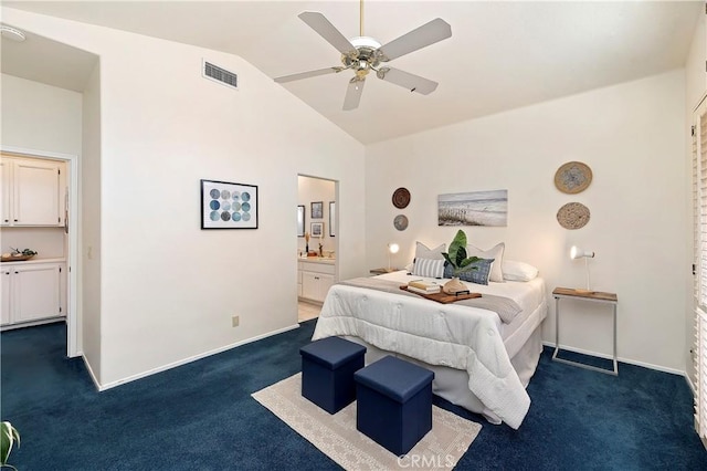 bedroom featuring ceiling fan, dark carpet, lofted ceiling, and connected bathroom