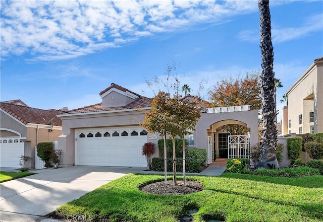 mediterranean / spanish-style home featuring a front lawn and a garage