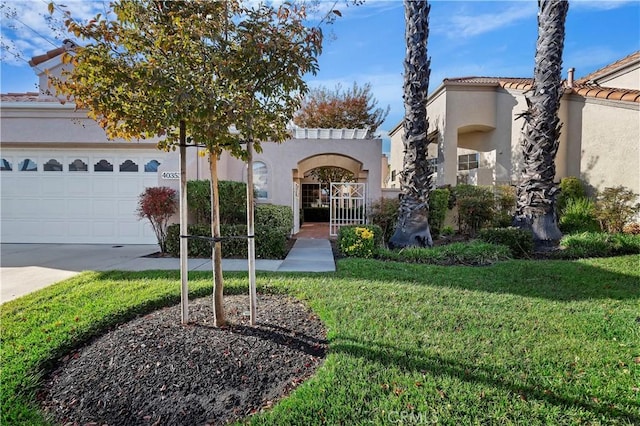 mediterranean / spanish house with a garage and a front lawn