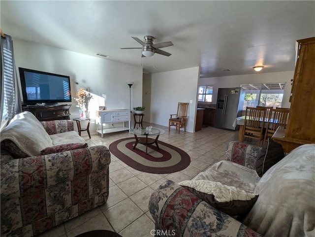 tiled living room with ceiling fan