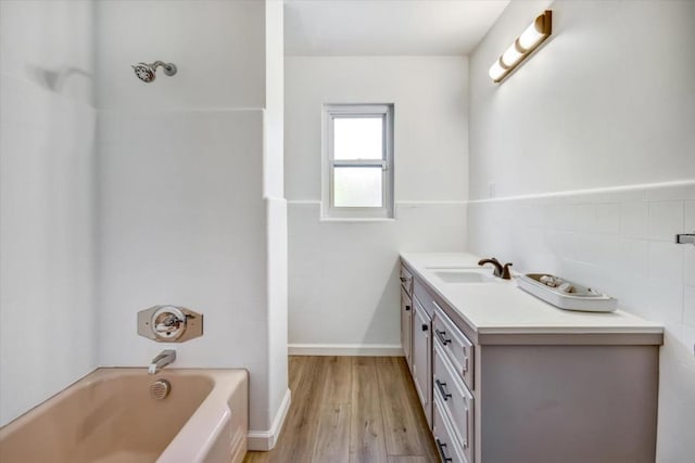 bathroom with vanity, tile walls, and hardwood / wood-style flooring