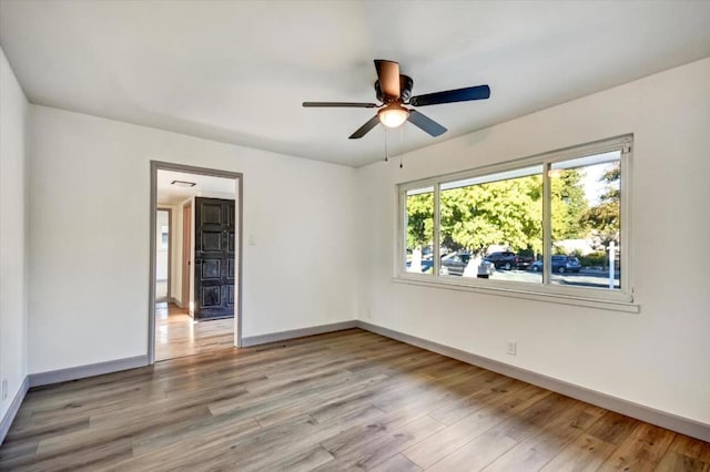 empty room featuring ceiling fan and light hardwood / wood-style floors