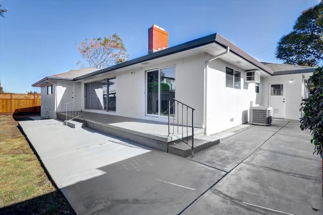 rear view of property featuring a patio area and cooling unit