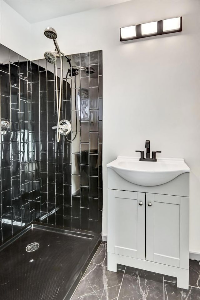 bathroom featuring vanity and tiled shower