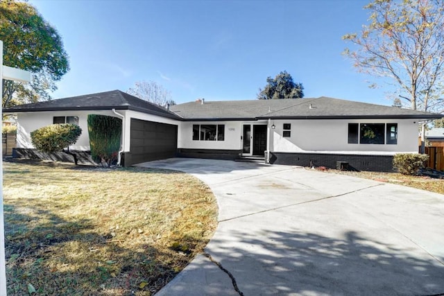 ranch-style home with a garage and a front yard