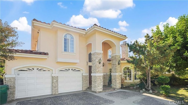 mediterranean / spanish-style home featuring a garage