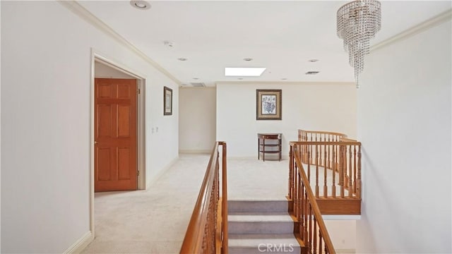 stairway with carpet flooring, an inviting chandelier, and ornamental molding