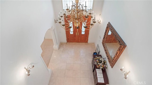 entryway featuring light tile patterned flooring and a chandelier