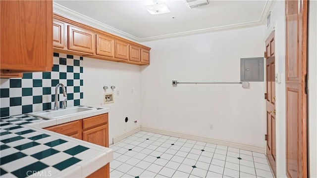 laundry area with cabinets, electric panel, hookup for a gas dryer, sink, and washer hookup