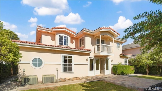 view of front of house featuring a balcony and cooling unit