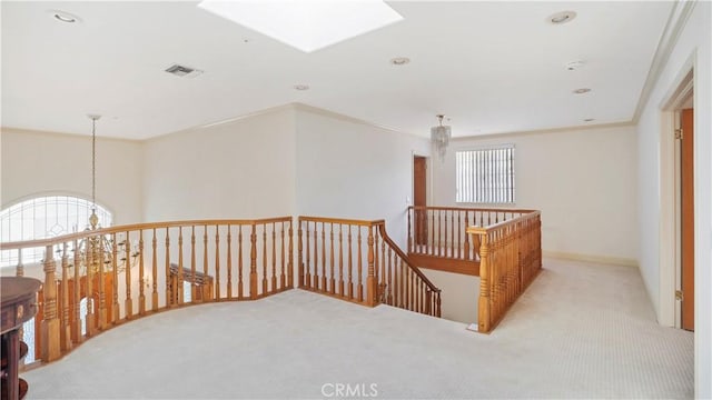 hall featuring light carpet and crown molding