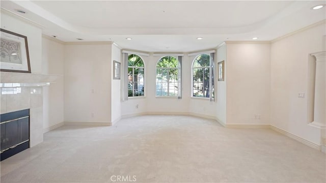 unfurnished living room with light colored carpet, ornamental molding, and a fireplace