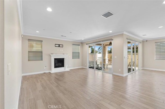 unfurnished living room with light hardwood / wood-style floors and ornamental molding