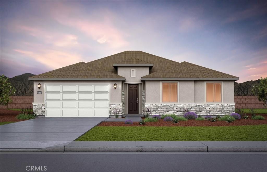 view of front of property with a garage and a lawn