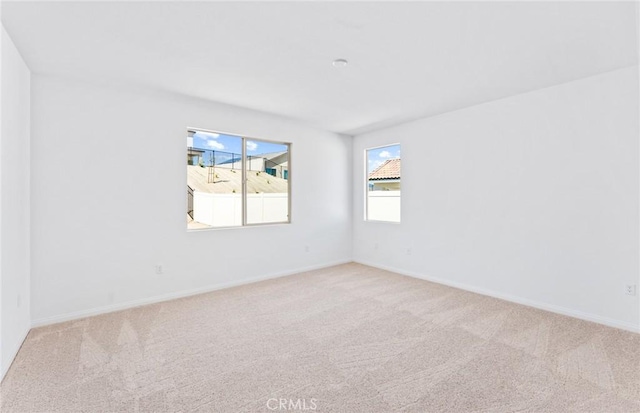 empty room with carpet flooring and baseboards